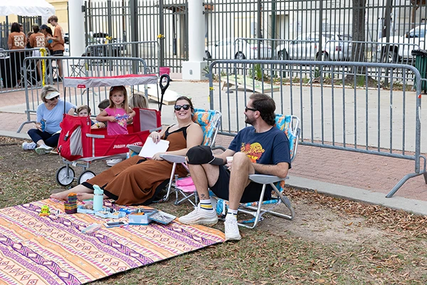 family with festival chairs and blanket enjoying the cookoff