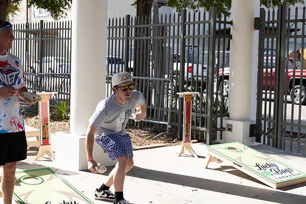 cornhole player tossing bag