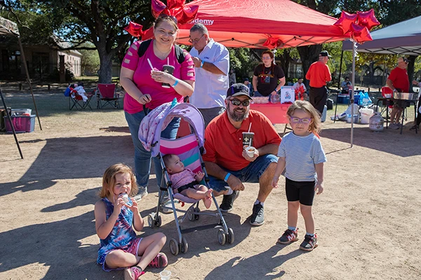 family with stroller smiling