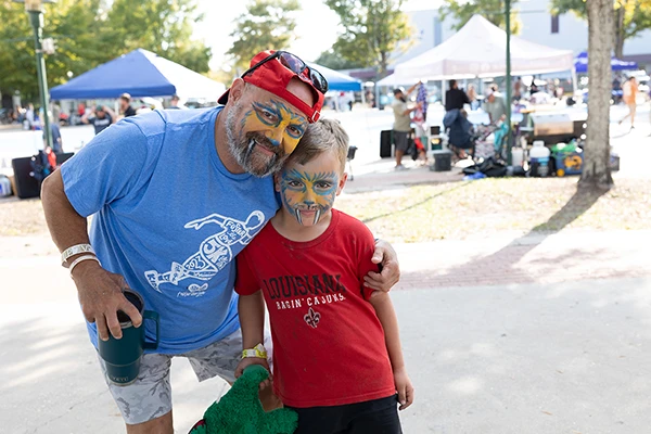 father and son with painted faces