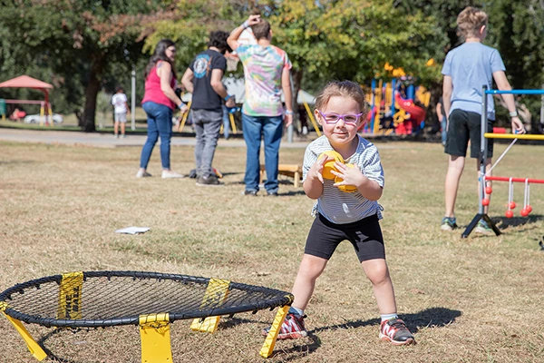 little girl playing spike ball