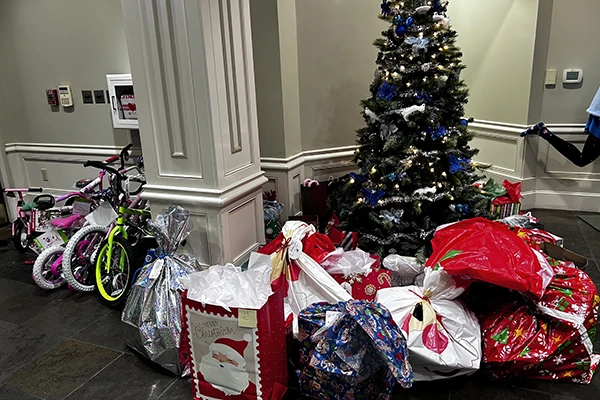 Christmas gift drive gifts and bike by tree