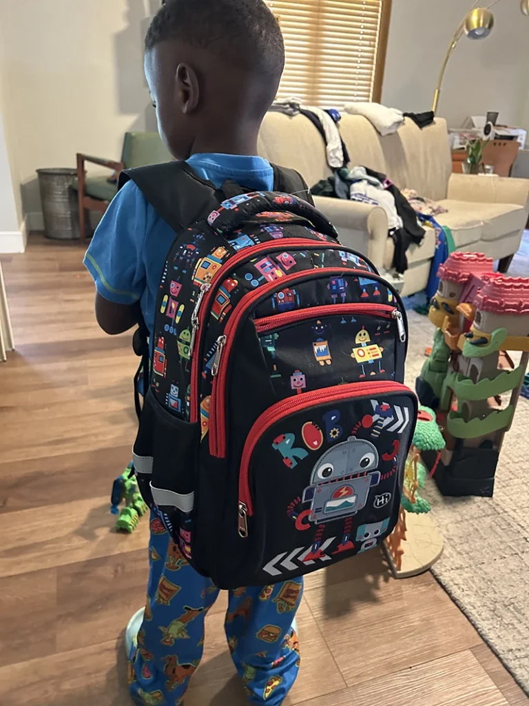 child wearing backpack from First Night Bags program