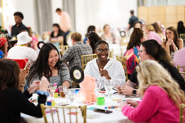 fundraiser guests sitting around table smiling