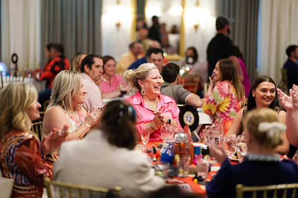 fundraiser guests sitting around table smiling