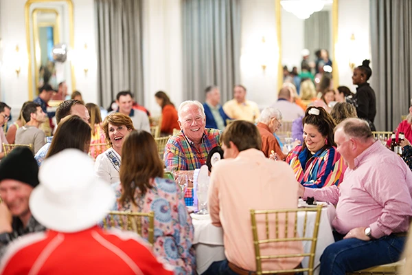 fundraiser guests sitting around table smiling