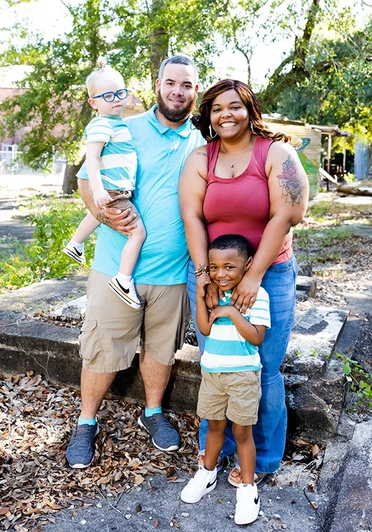 Family standing together outside smiling